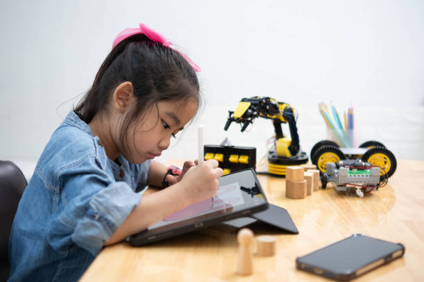 istock A young girl is playing with a remote control a robot 2129480491