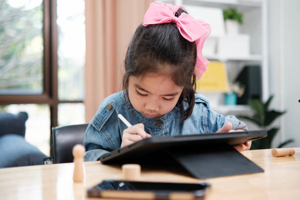 istock A young girl is playing with a remote control a robot 2129480501