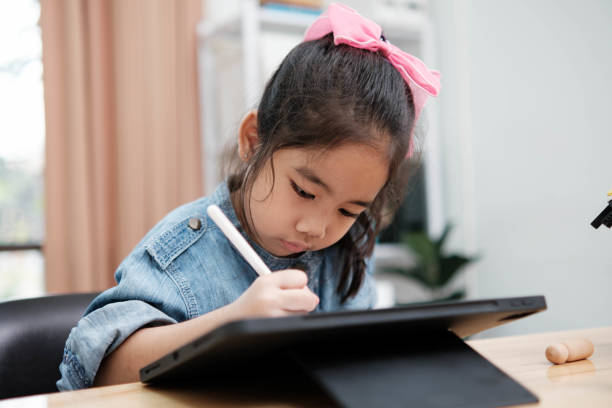 istock A young girl is playing with a remote control a robot 2129480517