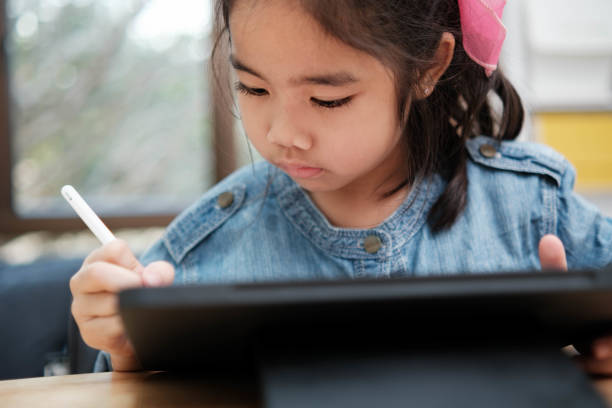 istock A young girl is playing with a remote control a robot 2129480519
