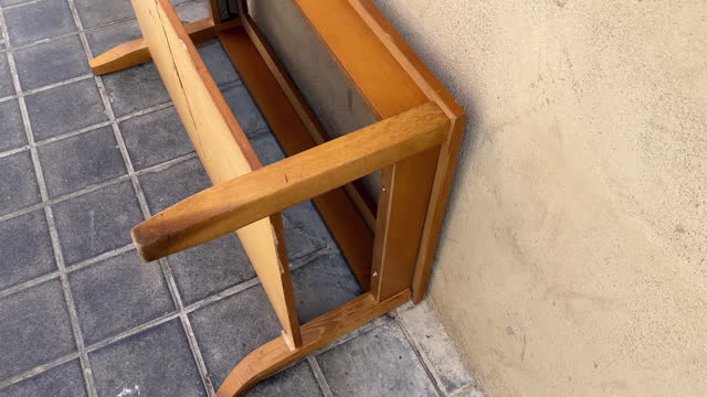 Small wooden table lying down on the sidewalk