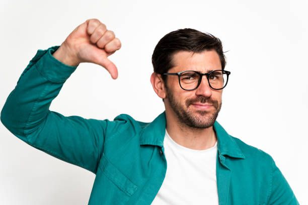 istock Disappointed man giving thumbs down gesture 2129489881