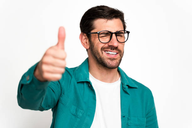 istock Smiling man giving thumbs up gesture 2129489895