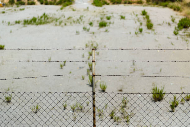 istock barbed wire fence close up 2129497314