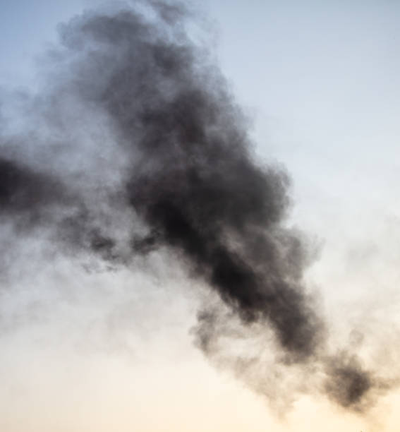 istock Black smoke against a blue sky 2129507512