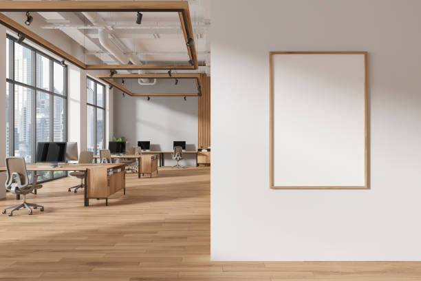 istock Gray and wooden open space office interior with poster 2129507527