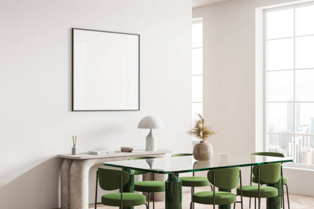 istock White dining room corner with green chairs and poster 2129508299