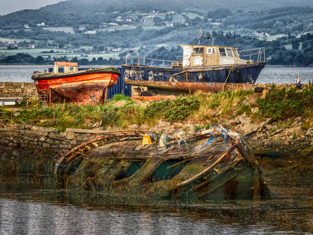 Cemetery old ships of Camaret-sur-Mer, Brittany, France - Broken ship hulls at a junkyard on the seashore