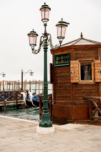 Wooden hut with gondola service and streetlight in front in Venice