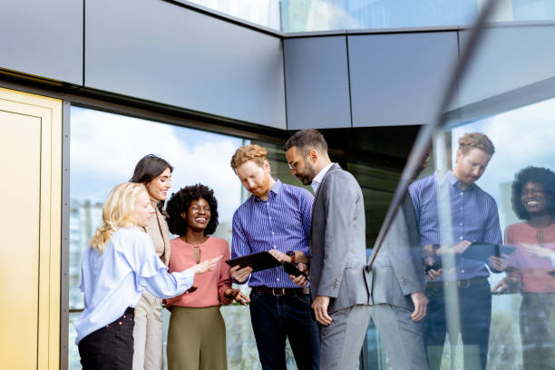 istock Business Professionals Engaging in a Strategy Discussion Outside a Modern Office Building 2129516618