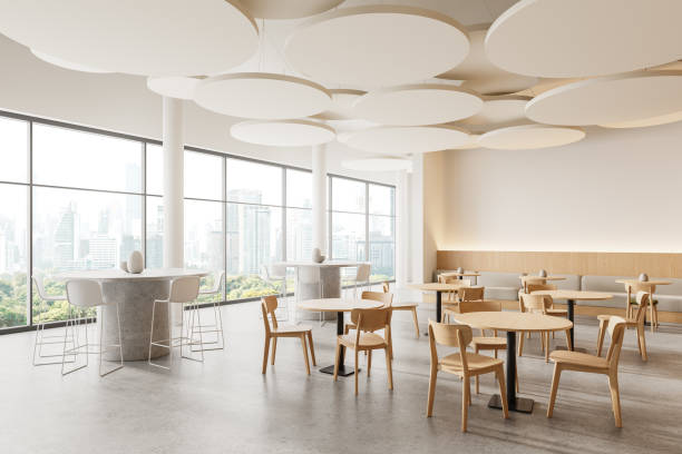 istock Stylish restaurant interior with chairs and tables, eating space and window 2129528456