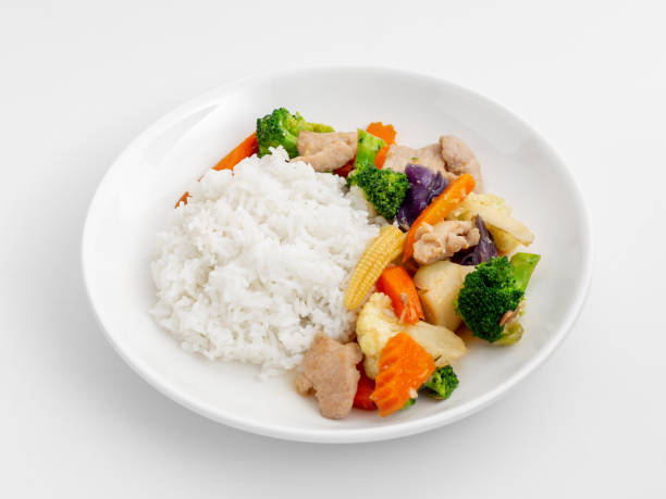 istock Stir-fried vegetables with cooked rice on white background 2129539252