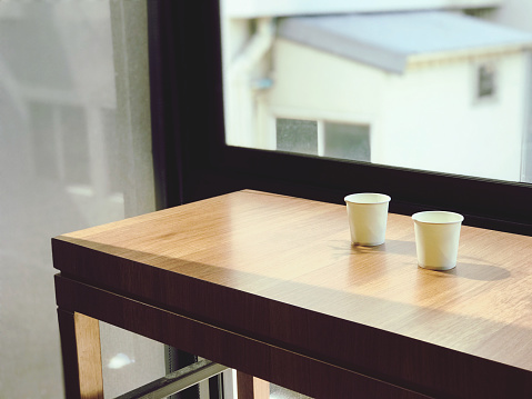 Coffee cup on wooden table in coffee shop, stock photo