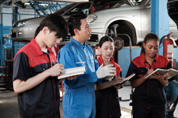 istock A supervisor engineer is training mechanic workers about car repair at a garage. 2129555968