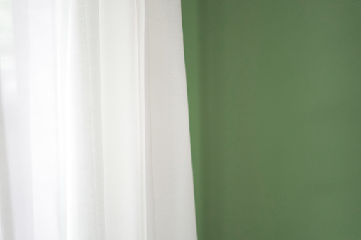 White curtains and green walls background