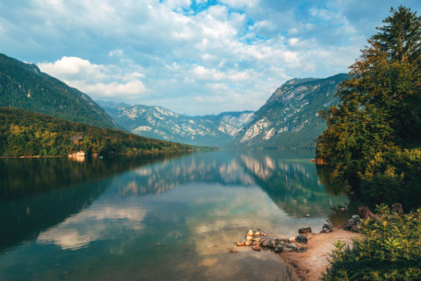 Lake Bohinj surrounded with Julian Alps mountains in Triglav national park in Slovenia Lake Bohinj surrounded with Julian Alps mountains in Triglav national park in Slovenia on summer morning julian alps stock pictures, royalty-free photos & images