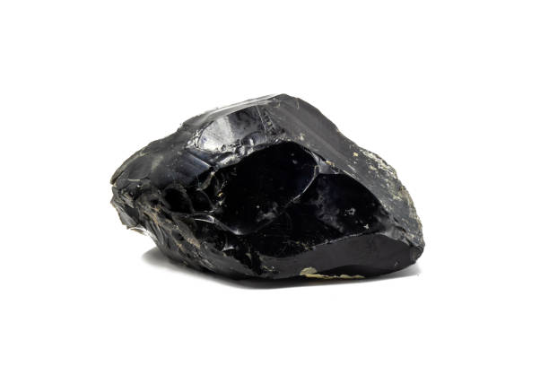 istock Raw black mineral obsidian, rock glass on isolated surface. Layers, edges and cracks are visible 2129577704
