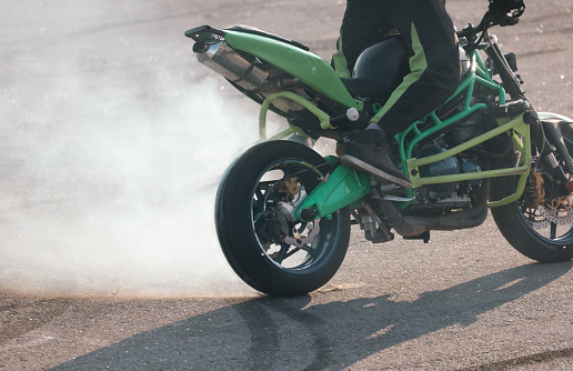 Smoke from under the wheel of a motorcycle.