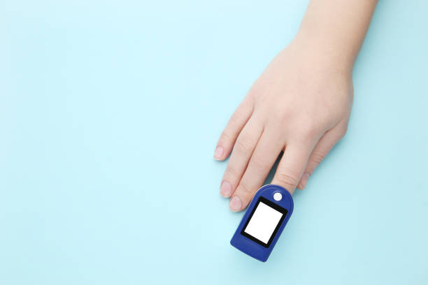 istock Pulse oximeter on finger on blue background 2129633590