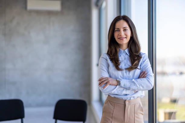 istock Successful businesswoman standing in creative office and looking at camera. 2129639892