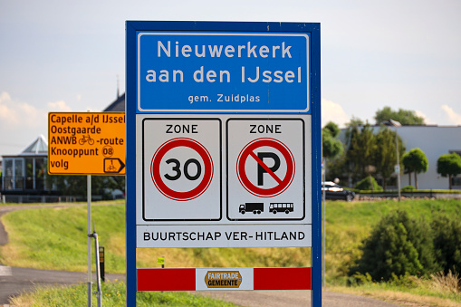 A blue road sign showing the direction to Budapest over a asphalted road, Hungary