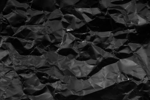istock Black crumpled paper background. Abstract background monochrome 2129653051