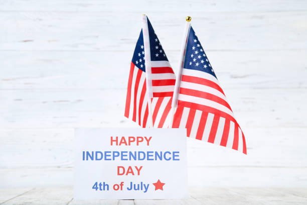 istock Text Happy Independence Day with flags on white wooden background 2129663345