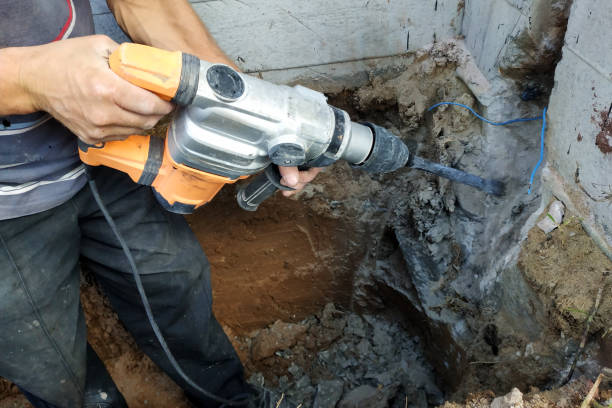 istock jackhammer in action, pneumatic construction tool, drilling a hole in the concrete wall. 2129675089