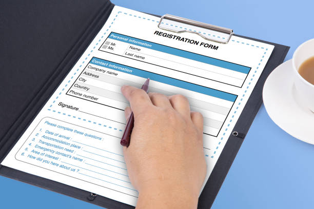 istock Blank registration form on clip board with someone hand. 2129678982