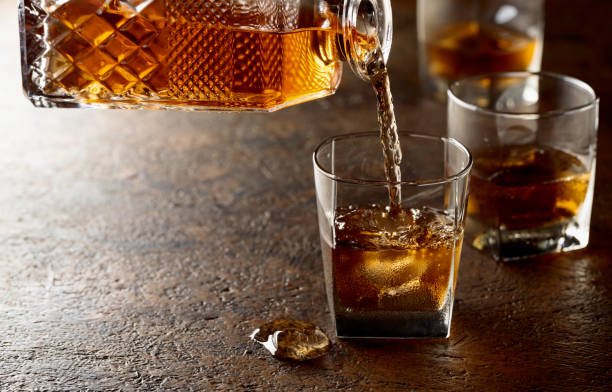 istock Pouring whiskey in glass with natural ice. 2129699002