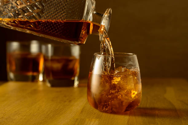 istock Whiskey is poured into a dammed glass with ice. 2129699100