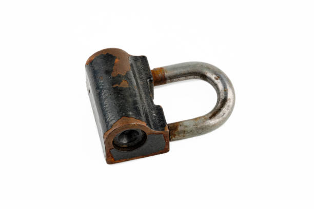 istock Close-up of a padlock with rust fragments highlighted on a white background. 2129725240