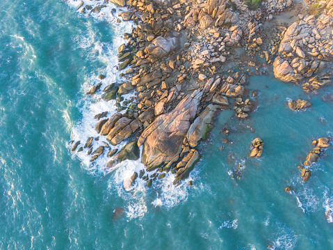 Aerial drone top view of beautiful waves crashing on the rocky island coast, ocean waves and fantastic. Ocean in Vietnam. Travel and seascape
