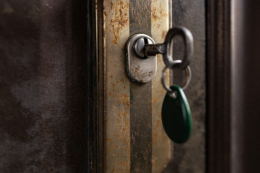 Keys stuck in a lock in vintage style.