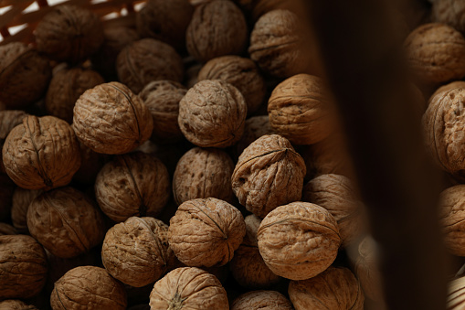 Walnuts with in wicker basket, close up