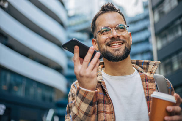 istock Young adult man walking, using phone and drinking takeaway coffee. 2129740575