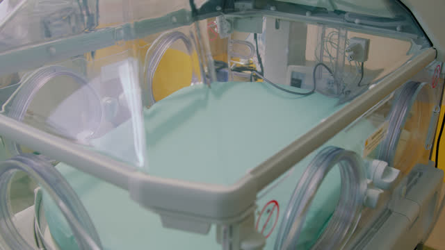 Within neonatal intensive care unit series of advanced incubators cater to needs of preterm infants. Gentle glow emanating from equipment illuminates room symbolizing hope and resilience.