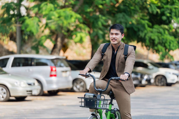 istock Young businessman ride bicycle to work. Reduce global warming Help save energy. Eco friendly concept 2129753302