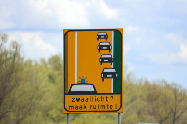 Two way traffic sign showing opposite directions on blue sky. Dilemma concept. Front view. Horizontal composition with copy space. Clipping path is included.