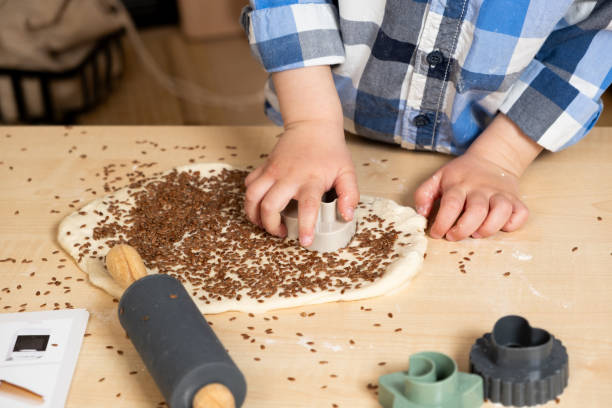 istock Childs hands making dough cookies using dough molds, hands close-up 2129766964