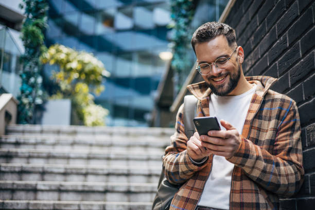 istock A man uses a smartphone to send messages on the street. 2129766973
