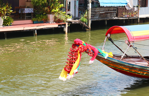 Flower garlands hung on Thai long tail boat prow for the offering to Mae Ya Nang Goddess