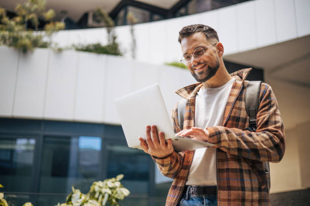 istock Adult young businessman using a laptop computer at financial district. 2129776912