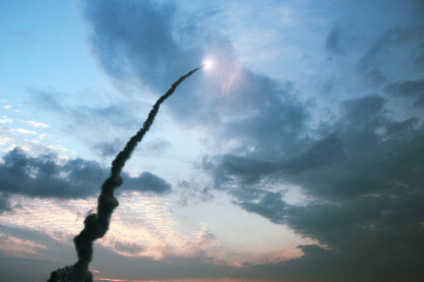 Successful launch of a rocket with a smoke trail into the sky with clouds. Space Shuttle ship take off through the clouds into space