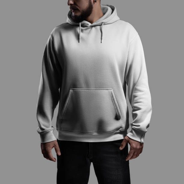 istock Mockup of a white oversized hoodie on a bearded man with his head turned, front view. 2129795986