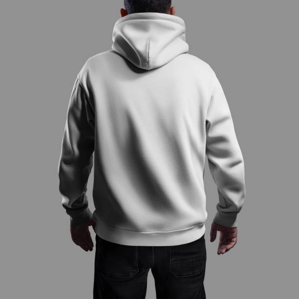 istock Mockup of a white oversized hoodie on a dark-haired man, back view. 2129797556