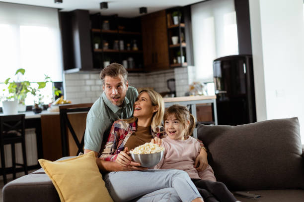 istock Family Movie Night: Engrossed in Thrilling Scenes at Home 2129821681