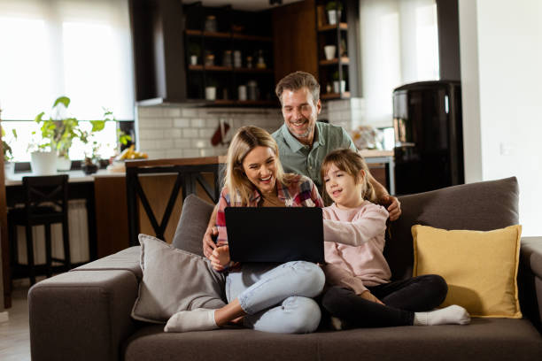istock Family Bonding Time With Laptop in Cozy Home Setting 2129821683
