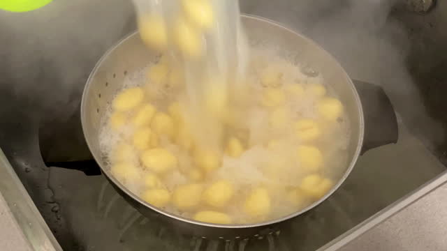 Draining gnocchi with old-fashioned colander