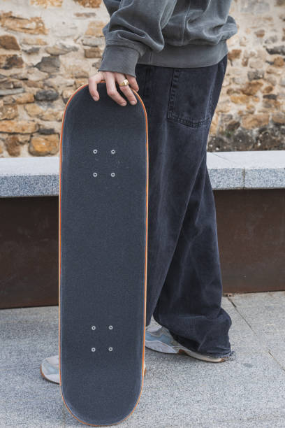 istock Young skateboarder holding his board outdoors. 2129824351